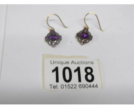 A pair of amethyst and diamond earrings