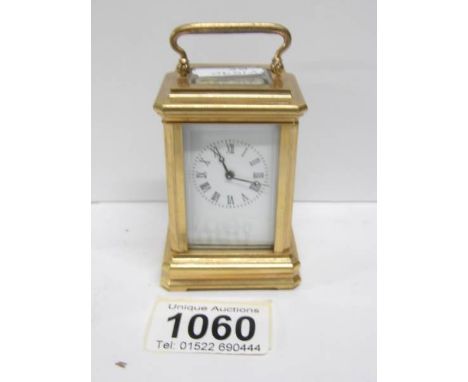 A miniature brass carriage clock