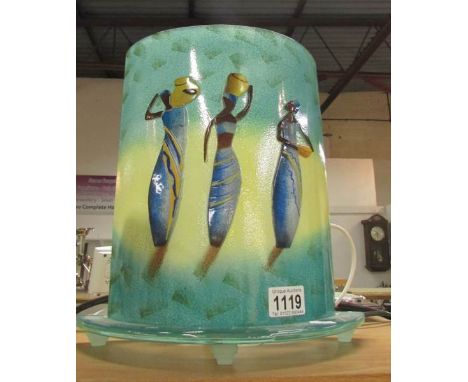 A retro style glass table lamp depicting figures of African women