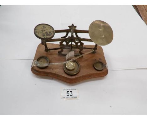 A set of brass and wood postal scales
