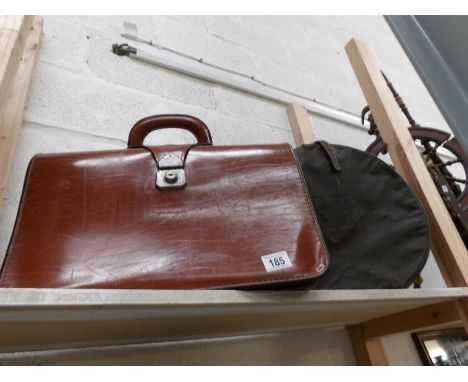 A vintage leather briefcase and a hat box
