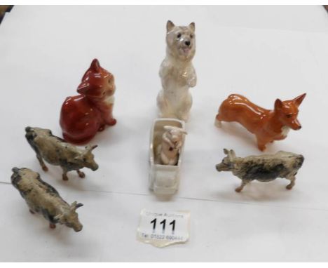 A Royal Doulton dog, Beswick cat, dog in car and 3 lead cows