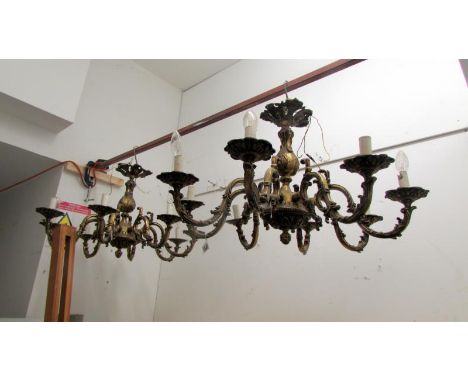 A pair of ornate 7 lamp ceiling lights