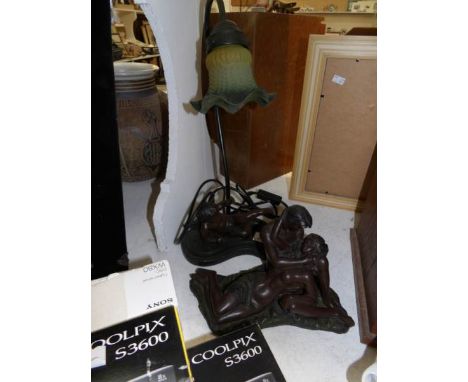 A bronzed resin cherub  table lamp and a bronzed resin romantic couple group