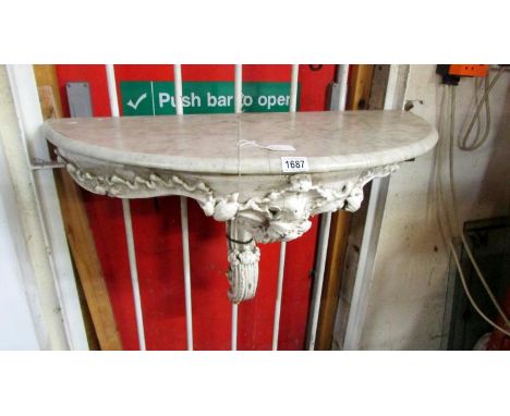 A marble top console table on metal base