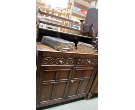 An oak cabinet with book shelf back