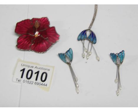 An enamel pendant and matching earrings together with an enamel flower brooch
