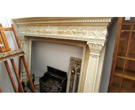 A large painted fire surround complete with grate