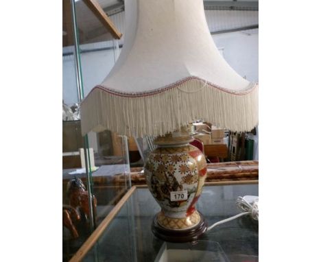 An oriental style table lamp with shade