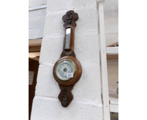 An Edwardian carved oak barometer