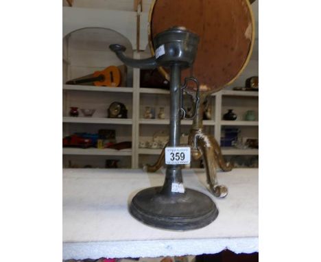 An antique pewter 'reed' lamp