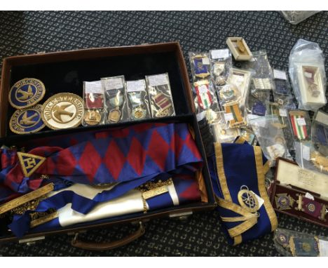 A collection of Masonic items belonging to F. W. Parker including apron, Worcester patches and various silver medals, togethe