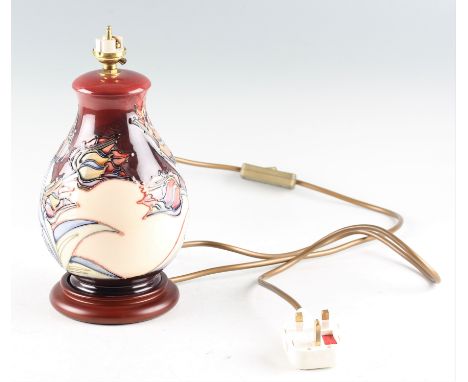 A Moorcroft table lamp with Red Tulip pattern designed by Sally Tuffin, on mahogany base. Height 26.5cm in total.