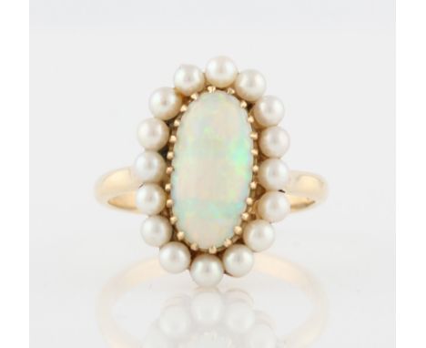 An opal and pearl cluster ring, set with a central oval opal cabochon, measuring approx. 13x7mm, surrounded by a border of pe