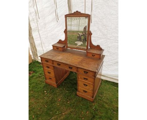 Light oak dressing table with mirror, complete with 9 lower drawers and adjustable table top mirror.&nbsp;