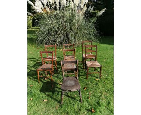 7 chairs to include 4 cane seated chairs, 2 reed seated chairs and an ash and elm ladder back chair.