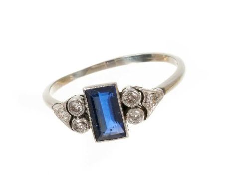 Art Deco sapphire and diamond ring with a rectangular step cut blue sapphire measuring approximately 8.6mm x 4.9mm flanked by