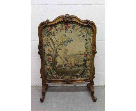 19th century French carved walnut fire screen, of cartouche form, raised on acanthus carved scrolled spread supports, enclosi