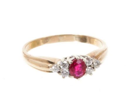 Ruby and diamond ring with an oval mixed cut ruby flanked by six brilliant cut diamonds in 9ct yellow gold setting. Ring size