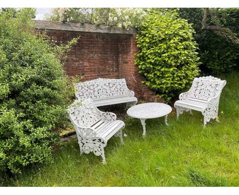 Victorian style white painted cast metal garden bench and a pair of matching chairs, together with a similar coffee tableTabl