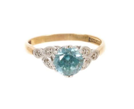 Blue zircon and diamond ring with a round mixed cut blue zircon measuring approximately 6.7mm in platinum claw setting with d