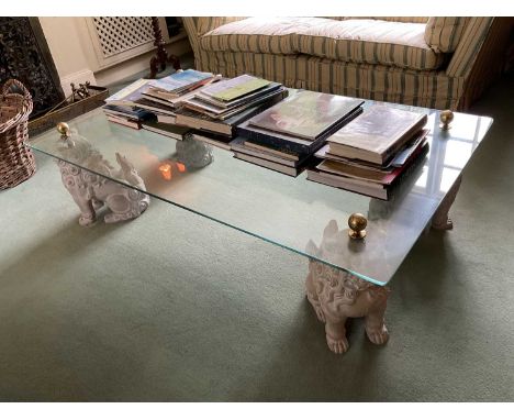 Decorative glass coffee table, with rectangular top on dog of foo ceramic supports152 x 91.5 cm, 40 cm high Good overall cond