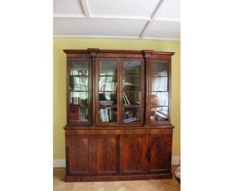 Good quality Regency flame mahogany two height breakfront bookcase with architectural pediment, the top with adjustable shelv