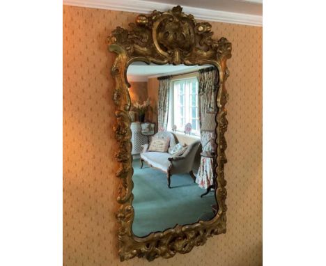 Early 18th century style pierced gilt gesso wall mirror, shaped plate within pieced C-scroll frame with foliate swags, 109 x 