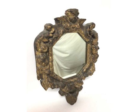 Continental Baroque carved giltwood wall mirror, with octagonal plate within heavy mask and scroll carved frame, probably 18t