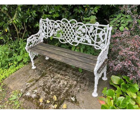 White painted cast iron bench, with lattice, vine and bird ornament