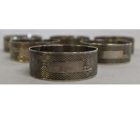 Set of 6 silver napkin rings with engine turned decoration and vacant Art Deco style cartouche, Sheffield 1938, maker C W Fle