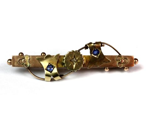 A Victorian hallmarked 9ct yellow gold bar brooch set with a diamond and two sapphires, L. 4.5cm.