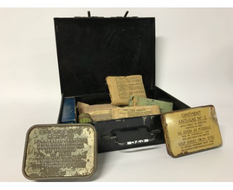A World War II military First Aid tin and contents, with a military Emergency Rations tin.