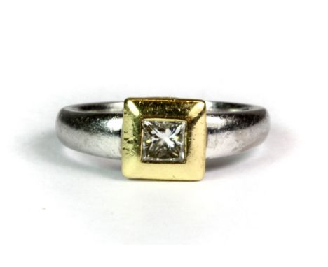 An 18ct yellow and white gold ring set with a princess cut solitaire diamond, (approx. 0.33ct diamond), (P).