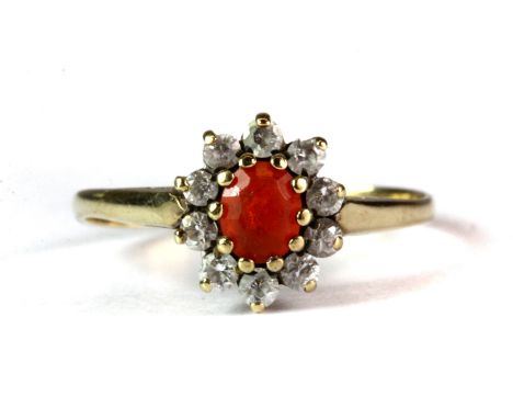 A 9ct yellow gold stone set cluster ring (O.5).