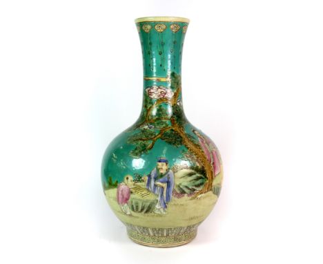 A fine Chinese hand enamelled porcelain bottle vase painted with five figures playing a board game beneath a pine tree, H. 41