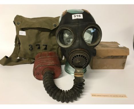 A World War II military gas mask manufactured by Avon and BW&ML Ltd, case and a first aid gas kit with a display glass dummy 