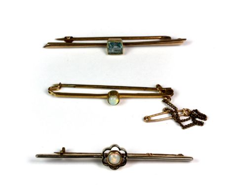 Two 9ct gold bar brooches and a further yellow metal (tested 9ct gold) bar brooch, one set with a blue stone and two set with