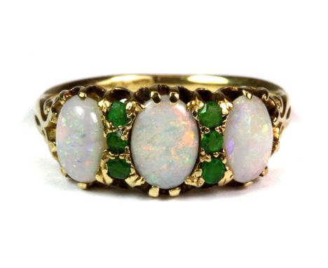 An 18ct yellow gold (stamped 18ct) ring set with opals and tzavorites (O).