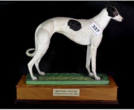A mounted matt ceramic figure of a greyhound, Westpark Mustard, on a wooden base, H. 29cm.