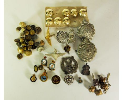 A large quantity of mixed British Army buttons, officer shoulder badges, enamelled military pins and other insignia.