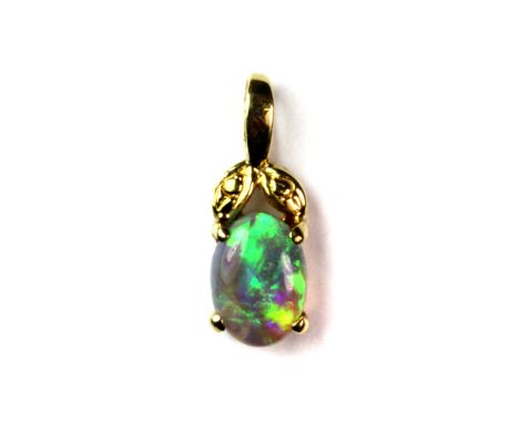 A pretty 18ct yellow gold (stamped 18ct) mounted blue opal pendant.