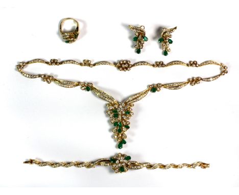 A stunning matching set of yellow metal (tested 18ct gold) necklace, earrings, ring and bracelet set with pear shaped emerald