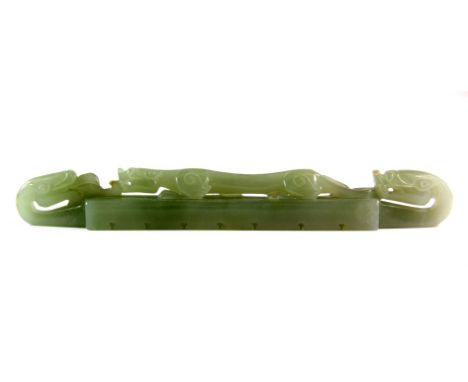 A fine 19th / early 20th century Chinese carved celadon jade brush rest, L. 18cm. Est. £600 - 800.