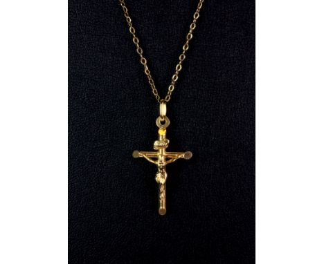 A 9ct yellow gold crucifix pendant and chain, (approx. 2.3gr).