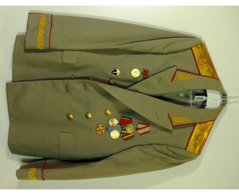 A Russian Army general dress jacket with several medal ribbons and banners.