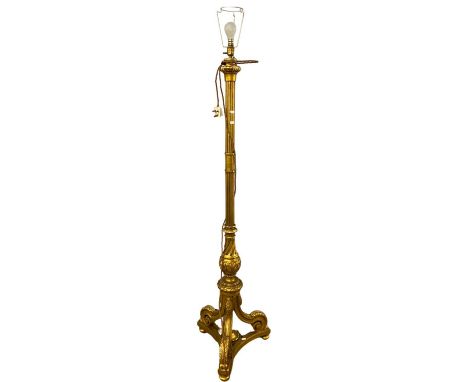 Early 20th Century ornate gilt wood standard lamp on three footed base, 185cm high including fittings
