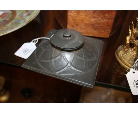 A LIBERTY STYLE TUDRIC PEWTER LIDDED INKWELL, of square form with typical Art Nouveau decoration and ceramic inkwell, marked 