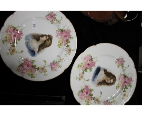 A PAIR OF ART NOUVEAU ROSENTHAL PORCELAIN WALL CHARGERS, with typical female portrait image to centre and floral border (2)