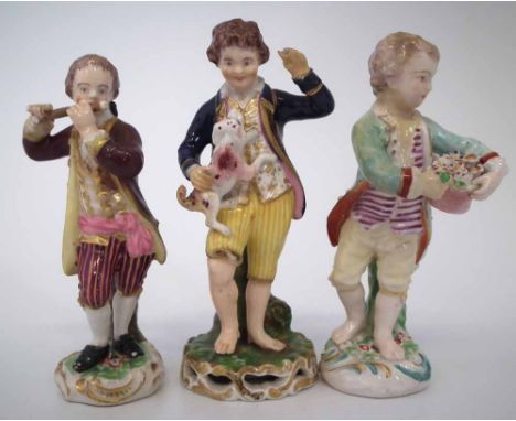 Three Derby figures of boys circa 1800 modelled playing the flute, one picking flowers, the third with pet dog, inscribed mar
